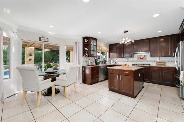 a kitchen with kitchen island granite countertop a sink and a counter top space