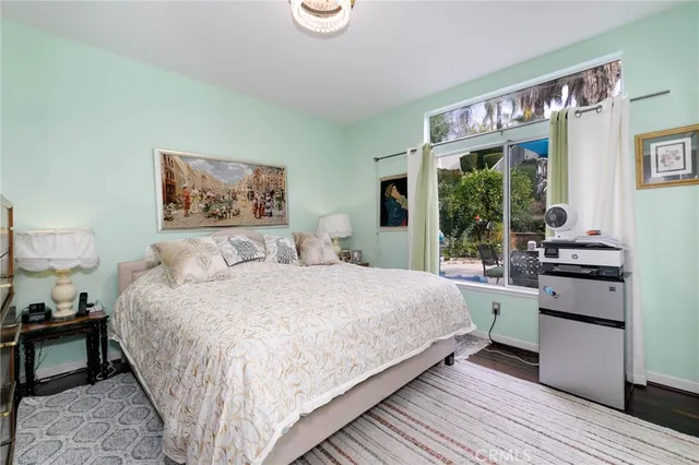 a bedroom with a large bed and a window