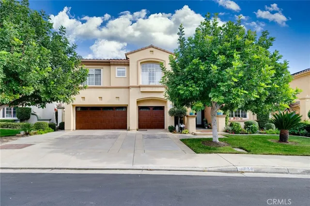 a front view of a house with yard and trees
