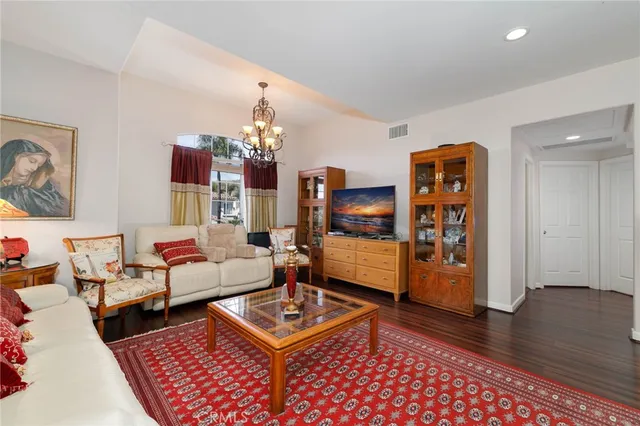 a living room with furniture and a chandelier