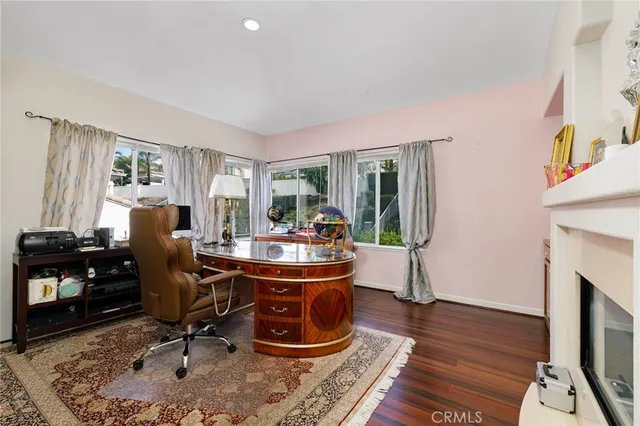 a view of a workspace with furniture and a window