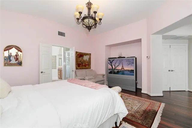 a bedroom with a bed and a chandelier