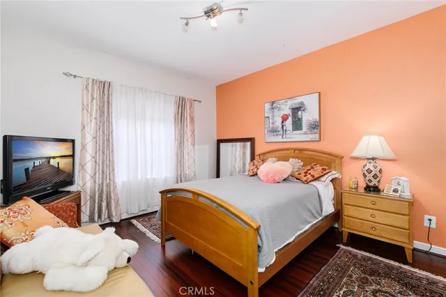 a bedroom with a bed and a painting on the wall