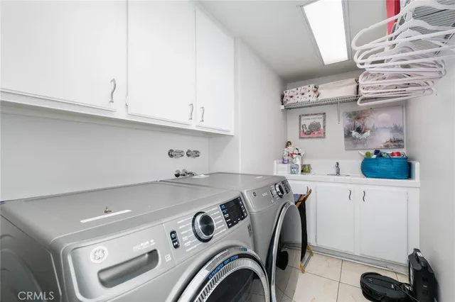 a utility room with sink dryer and washer