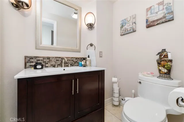 a bathroom with a sink mirror vanity and toilet