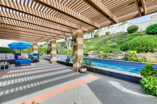 a view of a patio with table and chairs under an umbrella