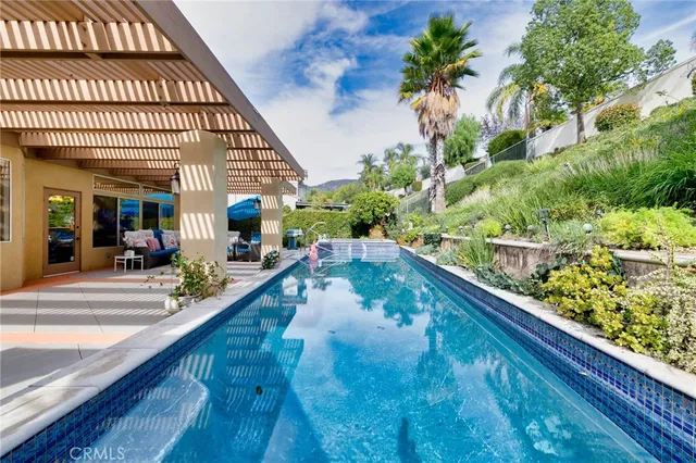 a view of a patio with a table and chairs under an umbrella