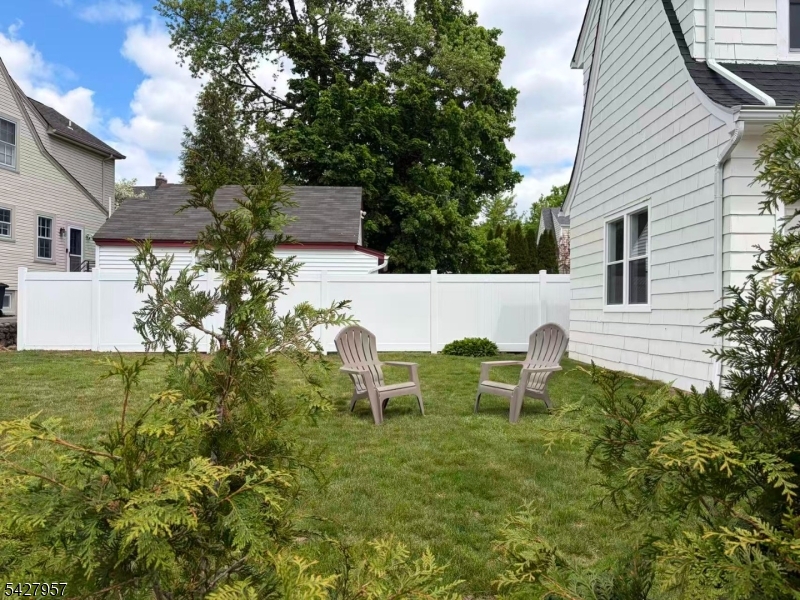 909 Ridgewood Road Millburn, NJ 07041 - Photo 26 of 33 a view of backyard of house with seating space