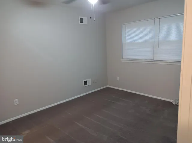 an empty room with a empty space and windows