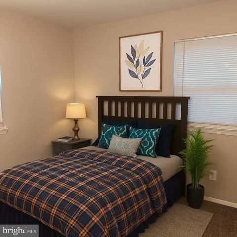 a bedroom with a bed and a painting on the wall