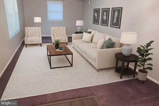 a living room with furniture and a painting on the wall