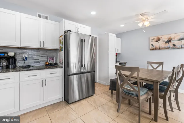 a kitchen with stainless steel appliances a stove a sink refrigerator and a microwave