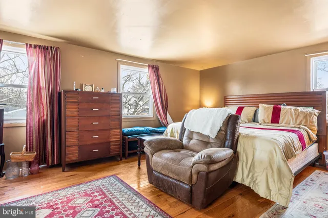 a bedroom with furniture and a rug