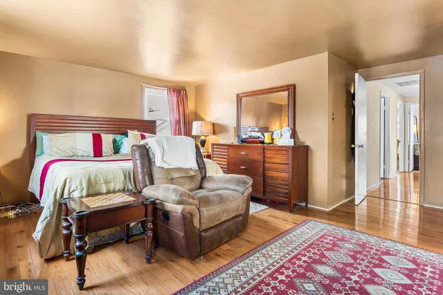 a bedroom with a bed and a large mirror in a bedroom