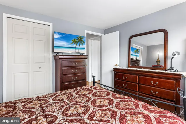 a bedroom with a bed a table and chair