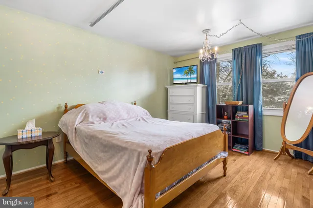 a bedroom with a bed and painting on the wall