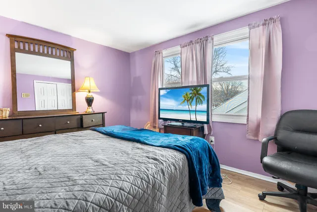 a bedroom with a bed and dresser