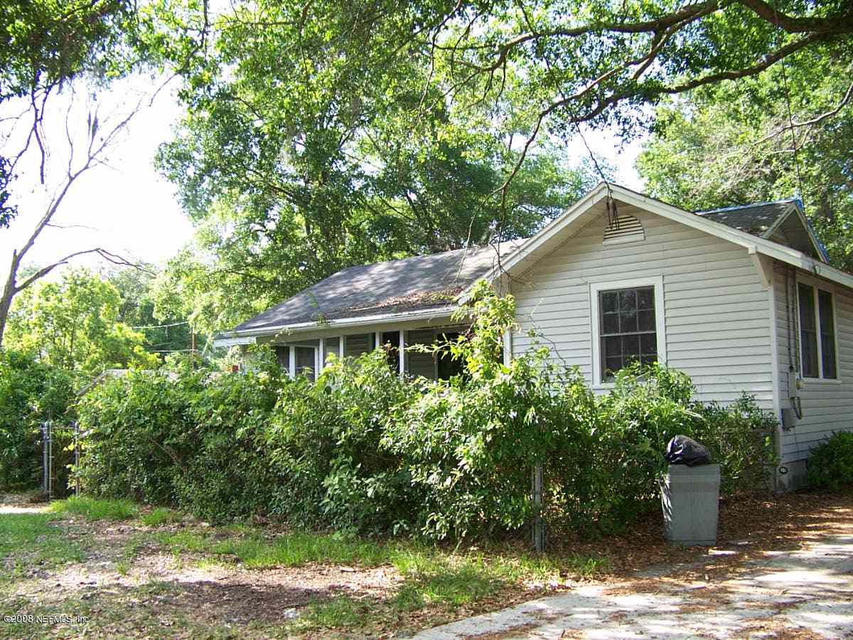 1133 Angus Street Jacksonville, FL 32208 - Photo 2 of 2 a view of a house with potted plants and large trees