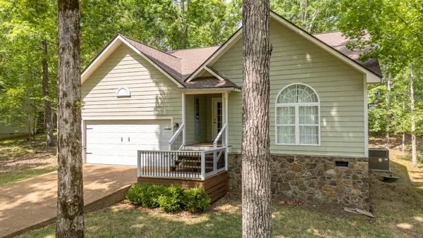 a front view of a house with a garden