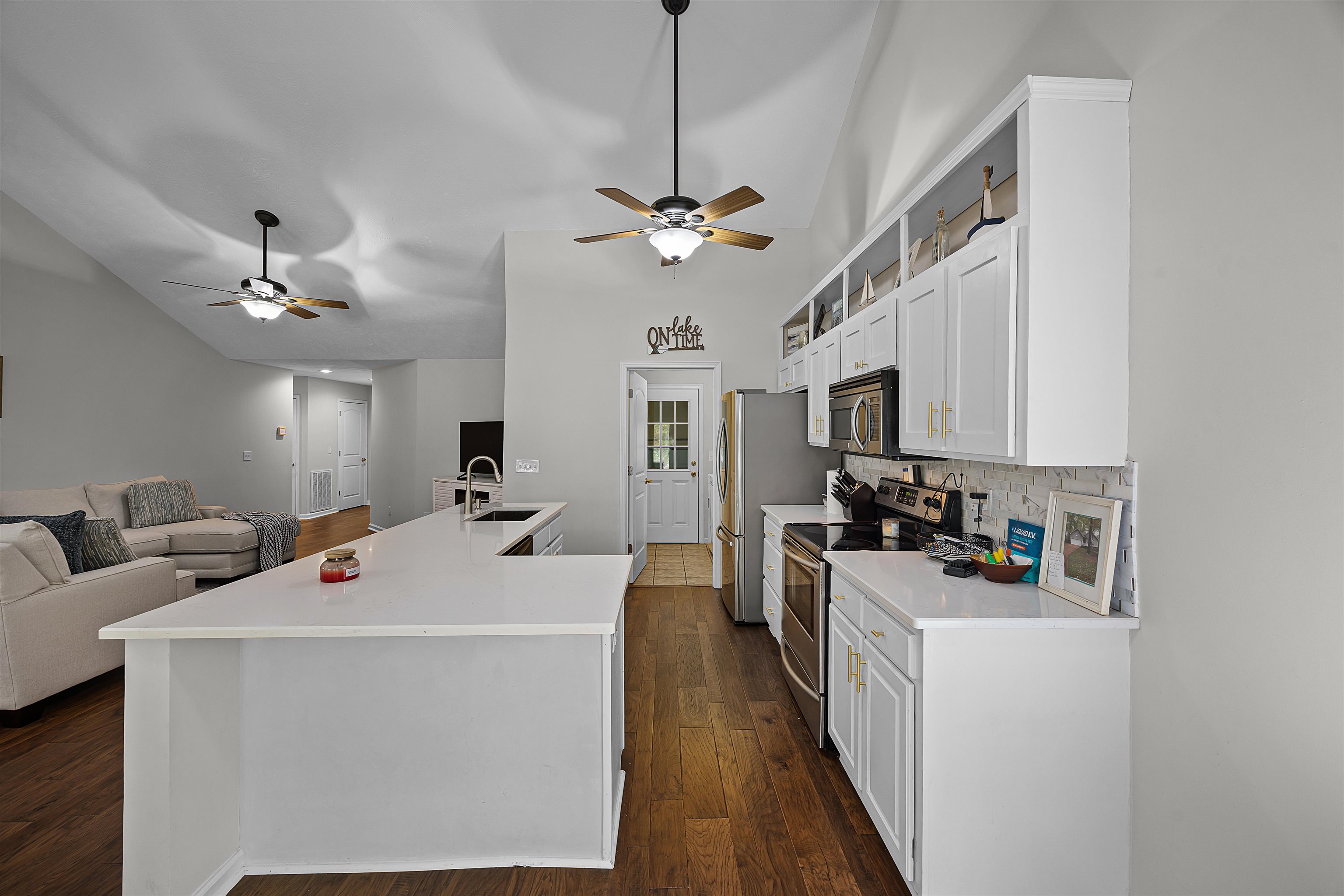 100 Masters Court Counce, TN 38326 - Photo 17 of 28 a living room with stainless steel appliances furniture a chandelier and a view of kitchen