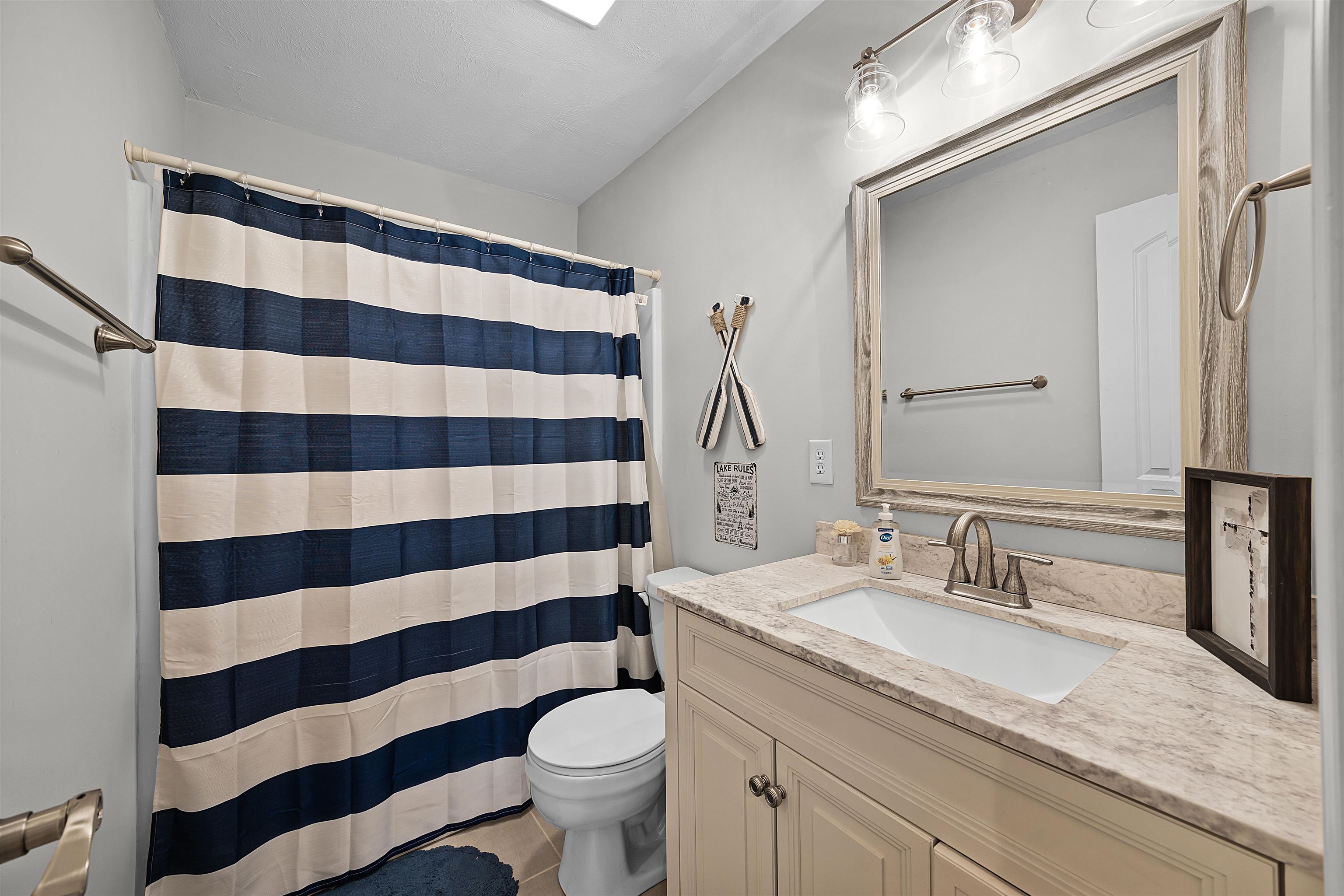 100 Masters Court Counce, TN 38326 - Photo 25 of 28 a bathroom with a sink a toilet a large mirror and shower curtain