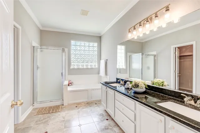 a bedroom with a bed and a dresser with wooden floor