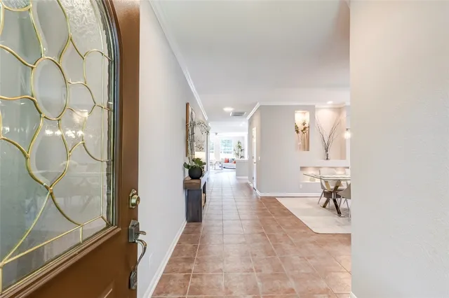 a view of a hallway with a couch and chandelier