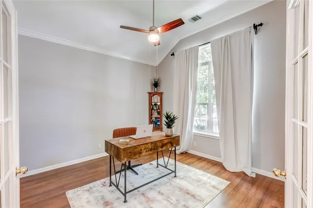 a workspace with wooden floor and a window