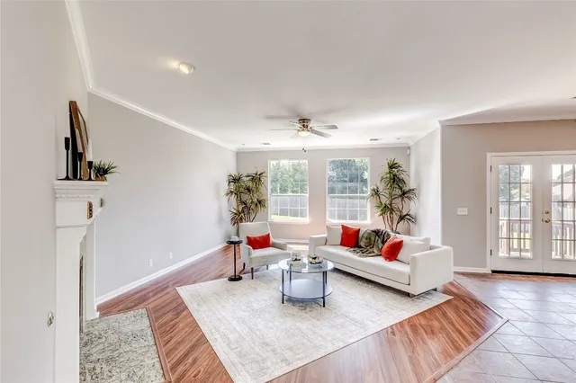 a living room with furniture and wooden floor