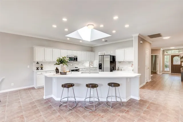 a kitchen with a table and chairs in it