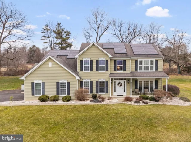 a front view of a house with swimming pool having outdoor seating