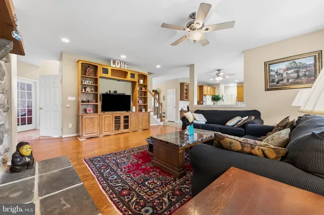 a living room with furniture windows and a flat screen tv