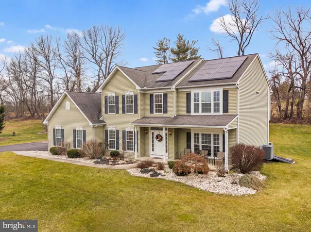 a front view of a house with swimming pool and porch