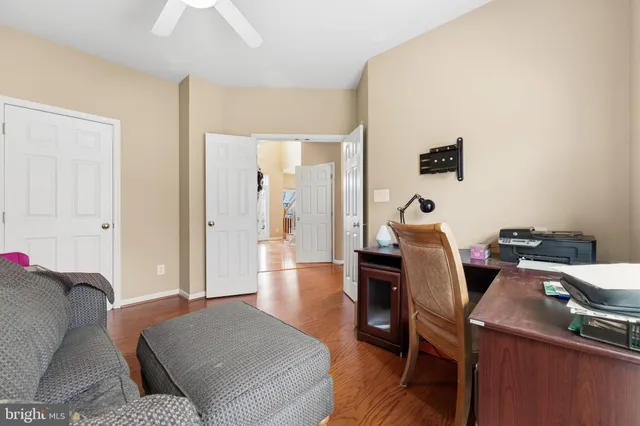 a living room with a couch and a wooden floor