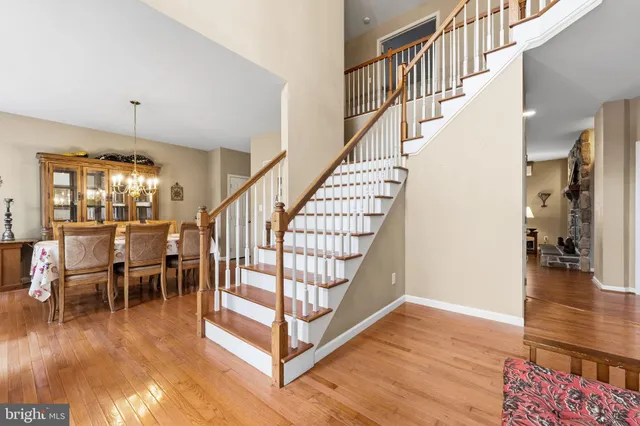 a bedroom with a bed chair and wooden floor