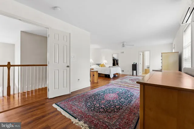 a bedroom with a bed a table and chair