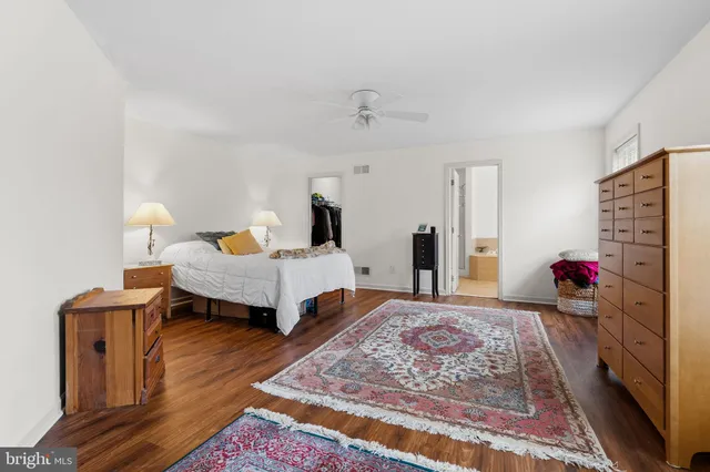 a bedroom with furniture and wooden floor