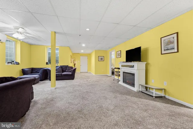 a view of a deck with couches table and chairs with wooden floor and fence