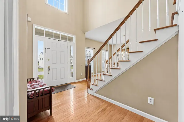 a view of entryway livingroom and hall with wooden floor