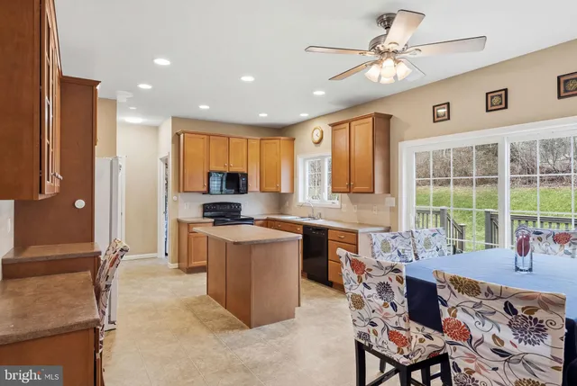 a kitchen with a sink a stove and a microwave