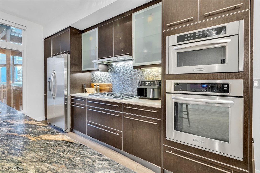 8925 West Flamingo Road, Unit 201 Las Vegas, NV 89147 - Photo 10 of 47 Pull out pantry, double ovens, glass cabinetry accents
