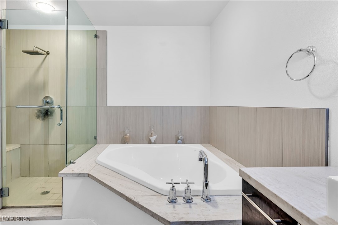 8925 West Flamingo Road, Unit 201 Las Vegas, NV 89147 - Photo 20 of 47 Glass and stone walk in shower with seat
