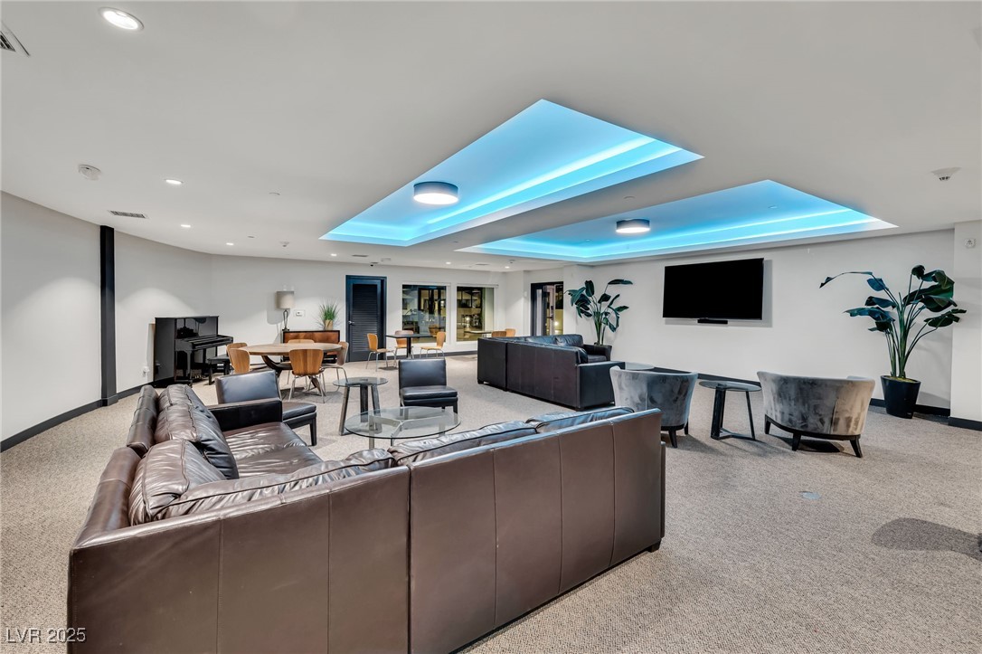 8925 West Flamingo Road, Unit 201 Las Vegas, NV 89147 - Photo 32 of 47 Clubhouse with large screen for viewing, piano, and tables for socializing