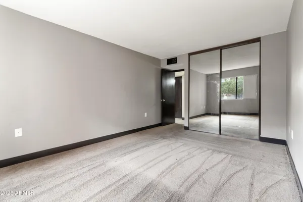 a bathroom with a granite countertop sink a mirror and shower