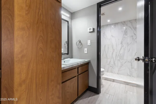 a room with a table chairs and a sink