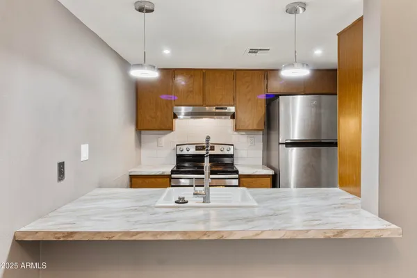 a view of a kitchen with a sink and a window