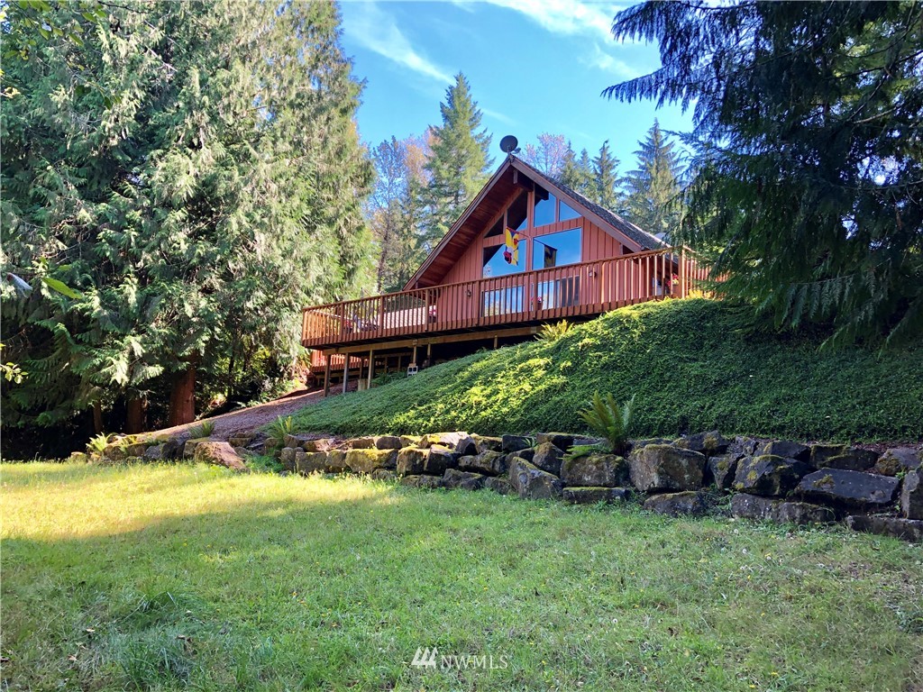 650 Frank Smith Road Toutle, WA 98649 - Photo 1 of 37 a view of a house with a big yard and large trees