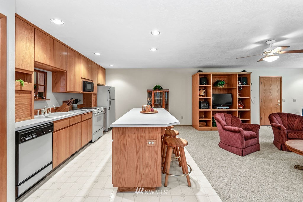 650 Frank Smith Road Toutle, WA 98649 - Photo 15 of 37 a kitchen with a refrigerator a sink dishwasher a dining table and chairs with wooden floor