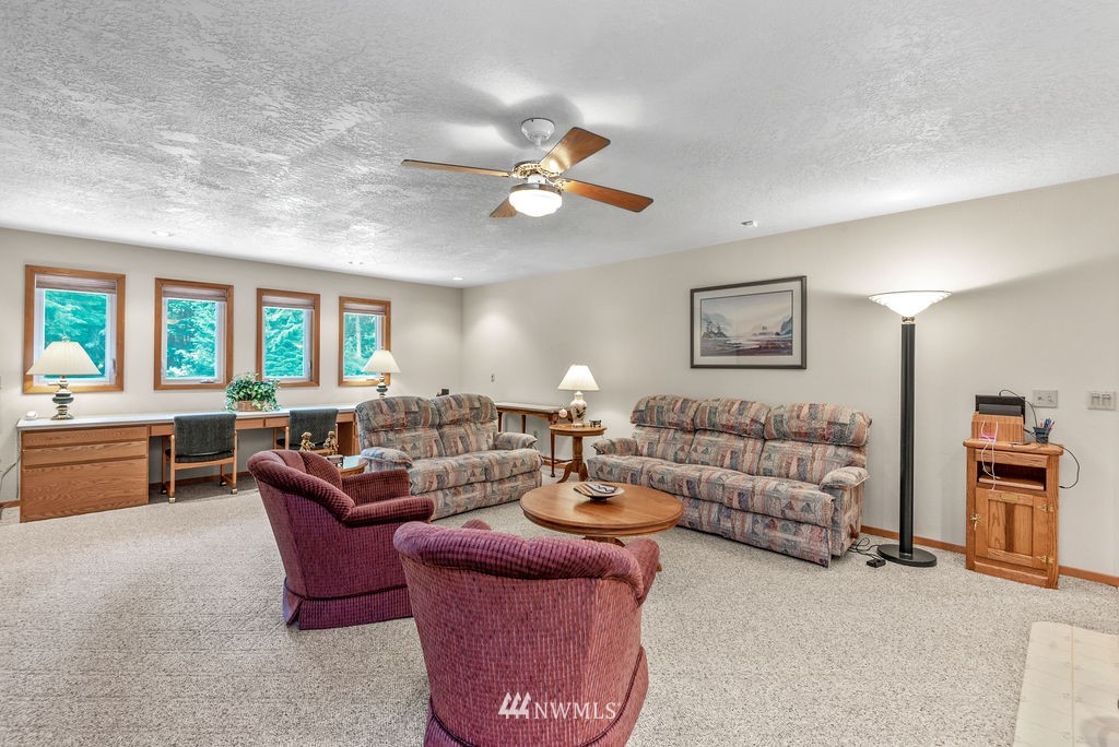 650 Frank Smith Road Toutle, WA 98649 - Photo 18 of 37 a living room with furniture a chandelier fan and a window