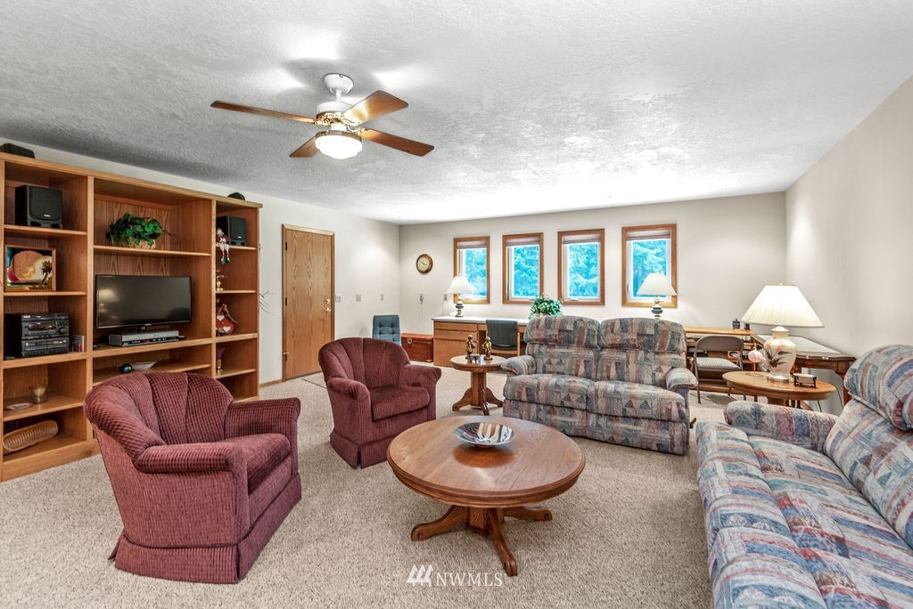 650 Frank Smith Road Toutle, WA 98649 - Photo 19 of 37 a living room with furniture a flat screen tv and a window